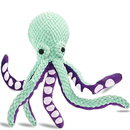 Plush octopus toy with green body and purple arms on a white background