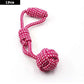 Pink and white rope toy on a white background