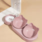 Pink pet bowl set with a water bottle on a beige background