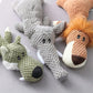 Three crocheted animal toys on a gray surface