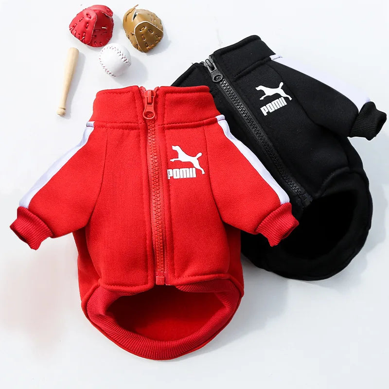 Red and black Puma pet jackets with sports equipment on a white background