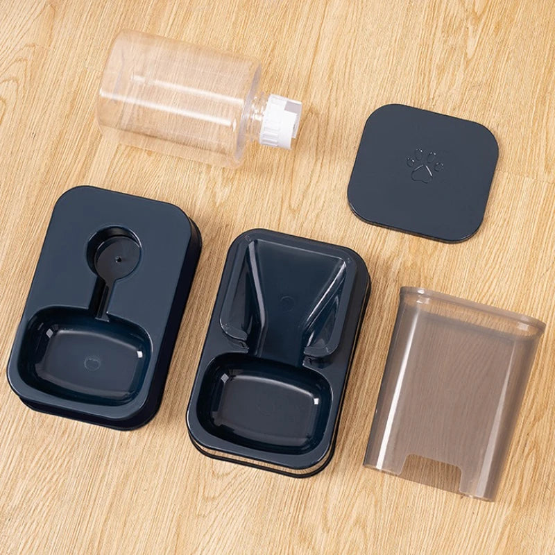 Set of black pet bowls and accessories on a wooden surface