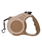 Beige retractable dog leash with handle and clip on a white background