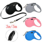 Set of four retractable dog leashes in black, gray, pink, and blue on a white background.