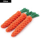 Three orange rope toys shaped like carrots on a white background