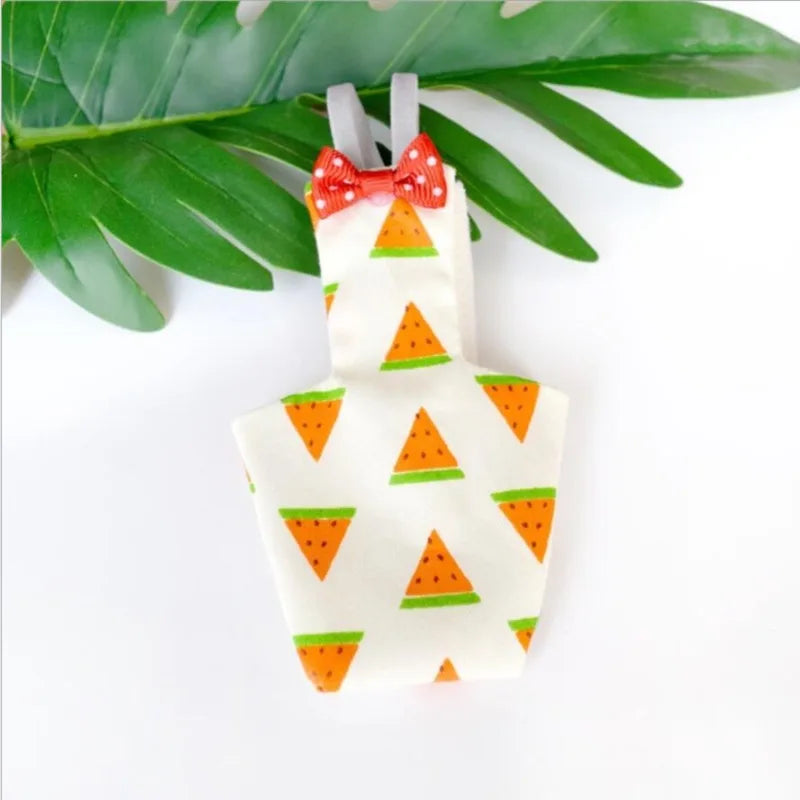 Phone case with watermelon pattern and red bow tie hanging on green leaves