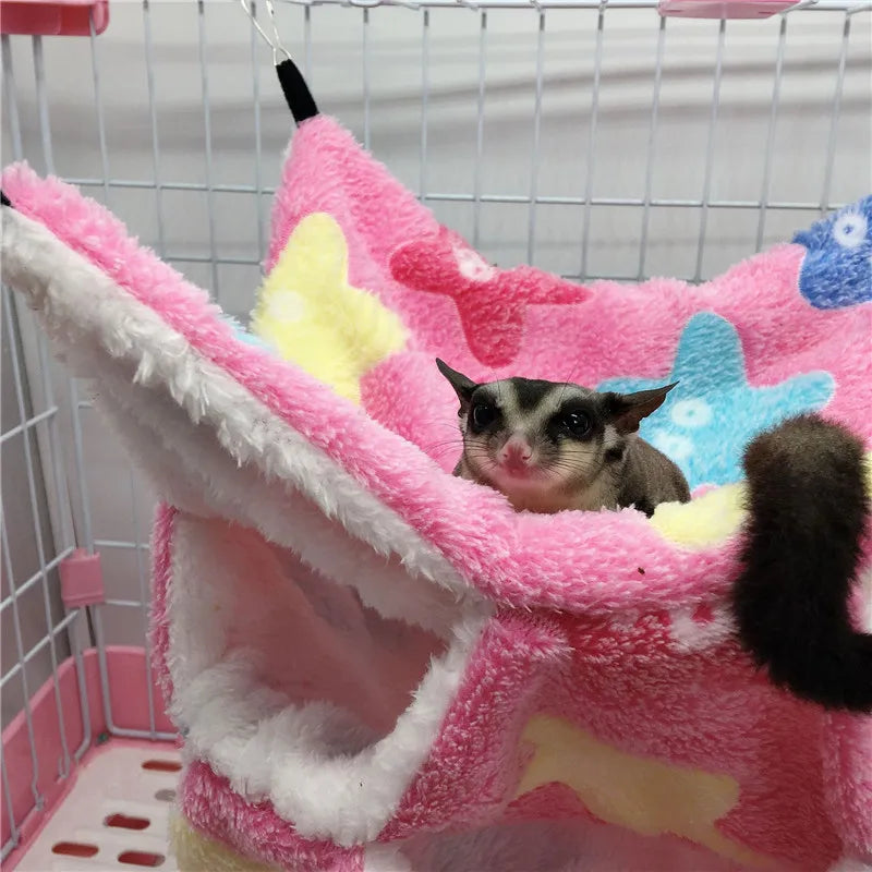 Pet in a colorful plush hammock inside a cage