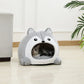 Cat lying inside a gray and white husky-shaped pet bed on a wooden floor.