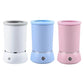 Three cylindrical humidifiers in white, blue, and pink on a white background