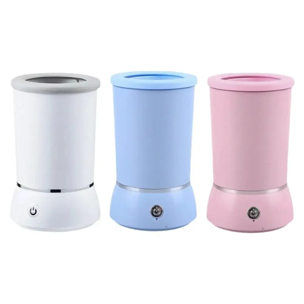 Three cylindrical humidifiers in white, blue, and pink on a white background