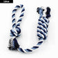 Blue and white braided rope toy on a white background