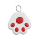 White keychain in the shape of a paw with red accents on a white background