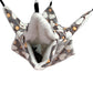 Plush pet hammock with gray, white, and orange pattern on a white background