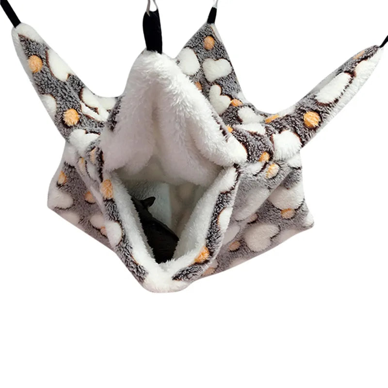 Plush pet hammock with gray, white, and orange pattern on a white background
