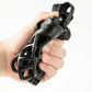 Black hand exerciser held in a hand against a white background