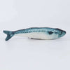 Fish toy with blue and white pattern on a light gray background
