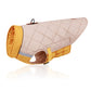 Quilted dog coat with beige body and yellow trim on a white background