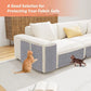 Sofa with a protective cover on a wooden floor, cats interacting with the cover.