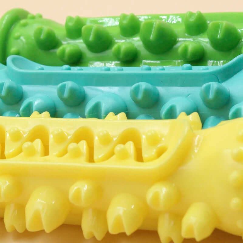 Three colorful silicone ice cube trays on a beige background