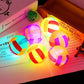 Colorful LED balls on a book with a colorful background
