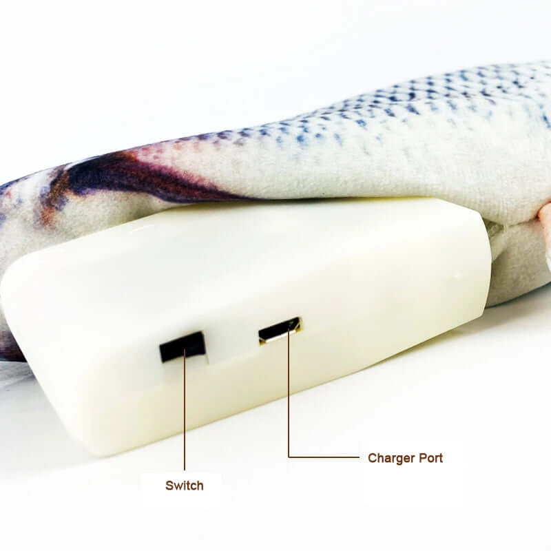 White heating pad with switch and charger port labeled, covered by a patterned blanket.