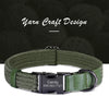 Green woven dog collar with a black metal buckle and engraved nameplate on a dark yarn background.