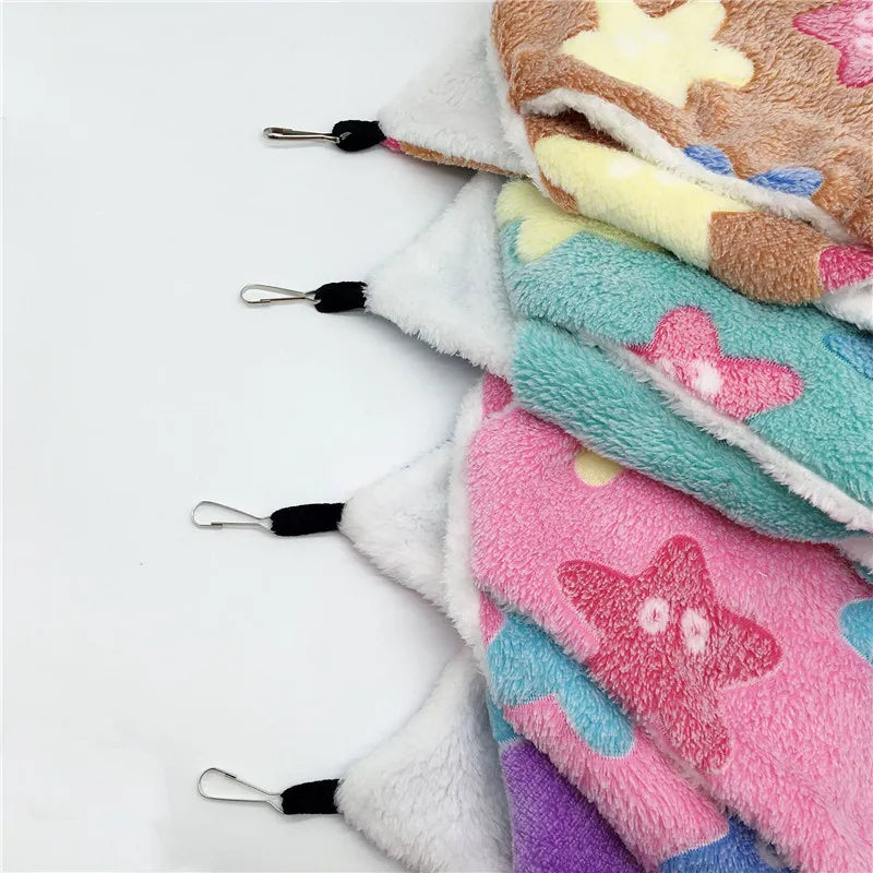 Stack of colorful fleece blankets with star patterns on a white background