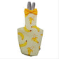 Pinafore with banana pattern and yellow bow tie on a white background
