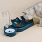 Cat using a blue pet feeder with multiple bowls on a beige surface.