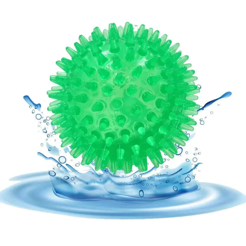 Green textured ball with water droplets on a white background