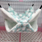 Pet hammock with cloud pattern in a cage