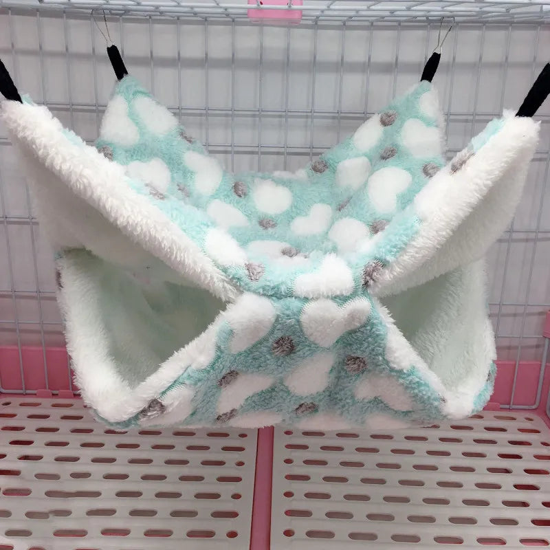 Pet hammock with cloud pattern in a cage