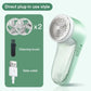 Green fabric shaver with cleaning brush and date cable on a white background