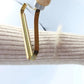 Gold vegetable peeler on a white background