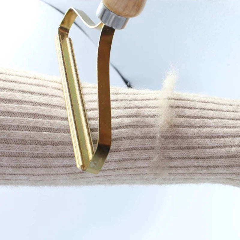 Gold vegetable peeler on a white background