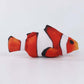Plush toy of a clownfish on a white background