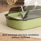 Green cat litter box with a scoop on a beige rug