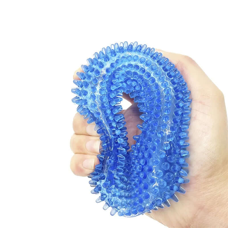 Blue textured ball held in a hand against a white background
