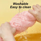 Pink fluffy object being washed with water, text 'Washable Easy to clean' on a yellow background