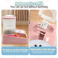 Pink pet feeder with automatic refill system on a wooden surface.