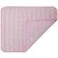 Pink quilted mat with a textured pattern on a white background