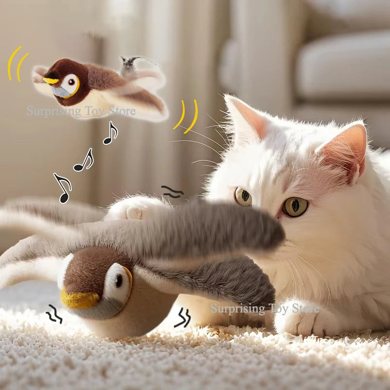 White cat playing with a toy mouse on a carpeted floor.