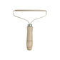 Metallic lint roller with wooden handle on a white background