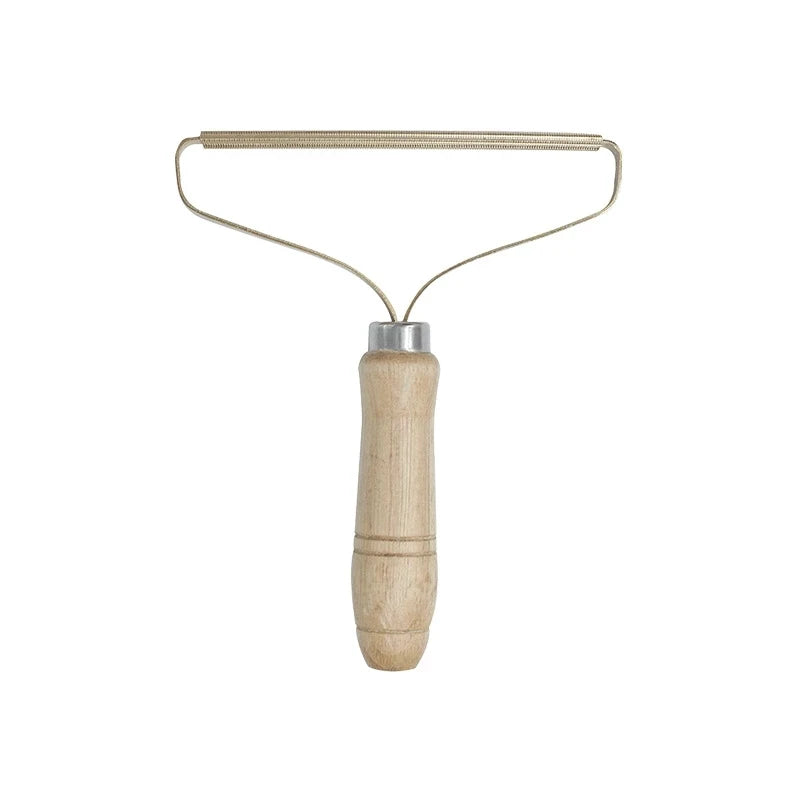 Metallic lint roller with wooden handle on a white background