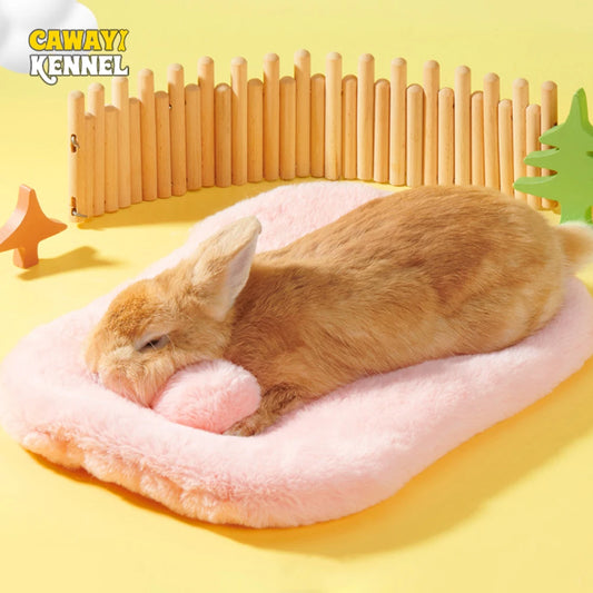Small brown rabbit sleeping on a pink cushion with a wooden fence and decorative items in the background, featuring the brand 'CAWAYI KENNEL'.