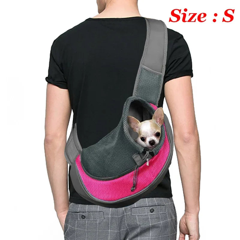 Person wearing a pink and gray pet carrier with a small dog inside, on a white background.