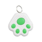 White paw-shaped keychain with green spots on a white background