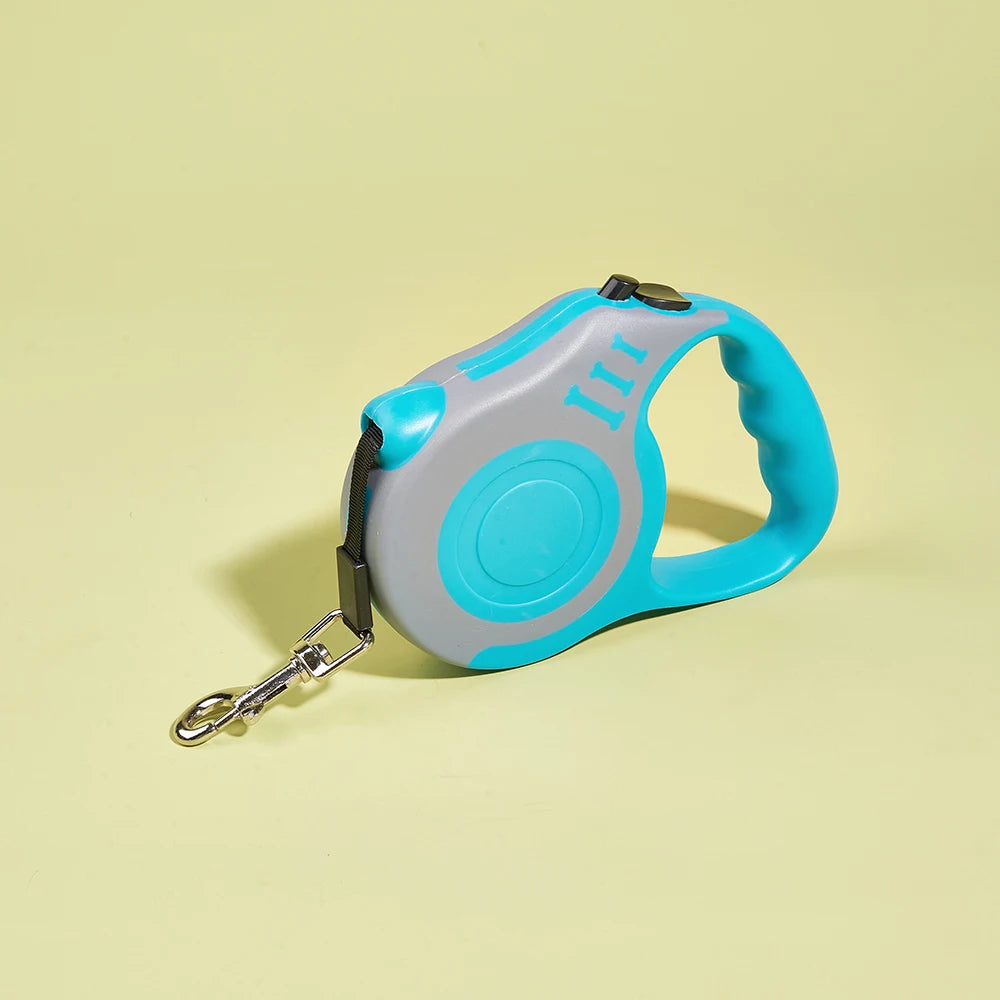 Retractable dog leash with blue handle and gray casing on a light yellow background