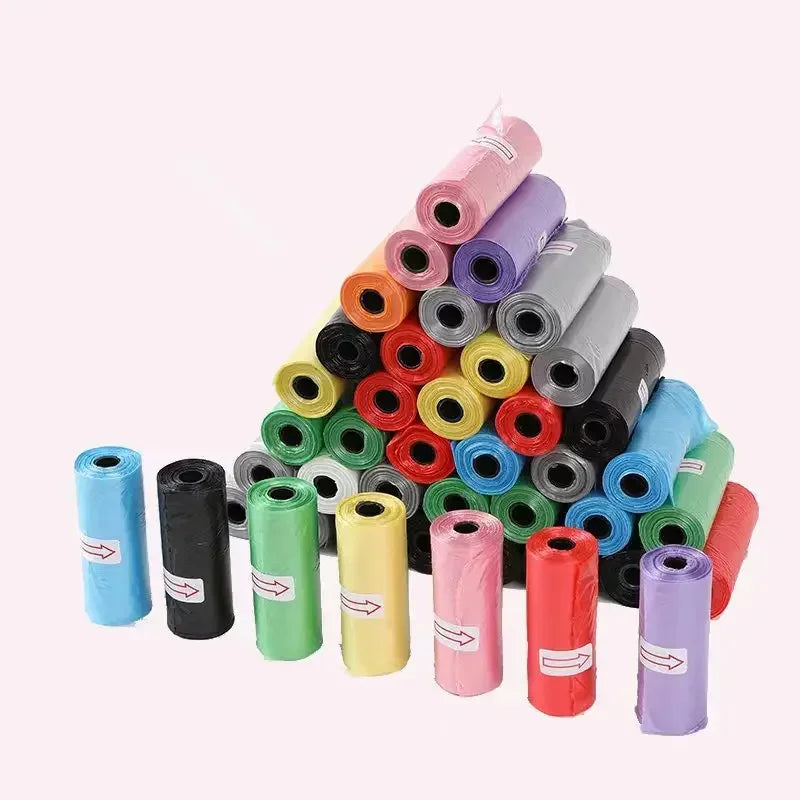 Assorted colored rolls of plastic bags arranged in a pyramid shape on a white background.