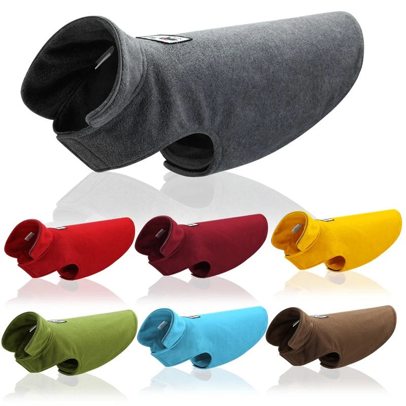 Collection of colorful dog coats on a white background